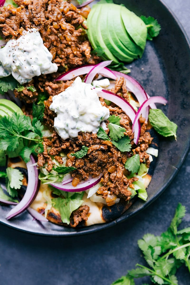 Overhead view of Ground Beef Naan Tacos with all the toppings.