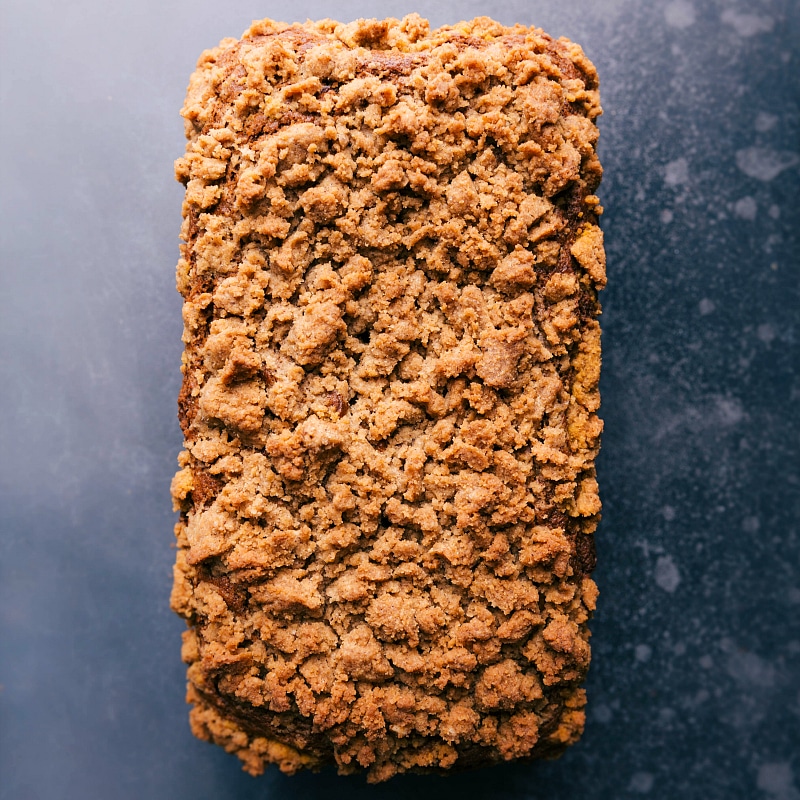 Freshly baked pumpkin bread with golden streusel topping.