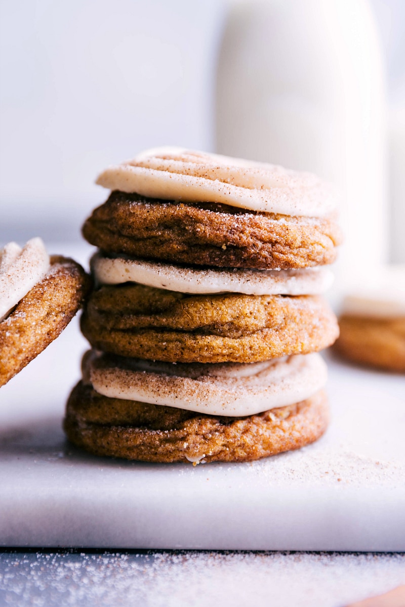 Image of Pumpkin Cinnamon Roll Cookies stacked on top of each other.