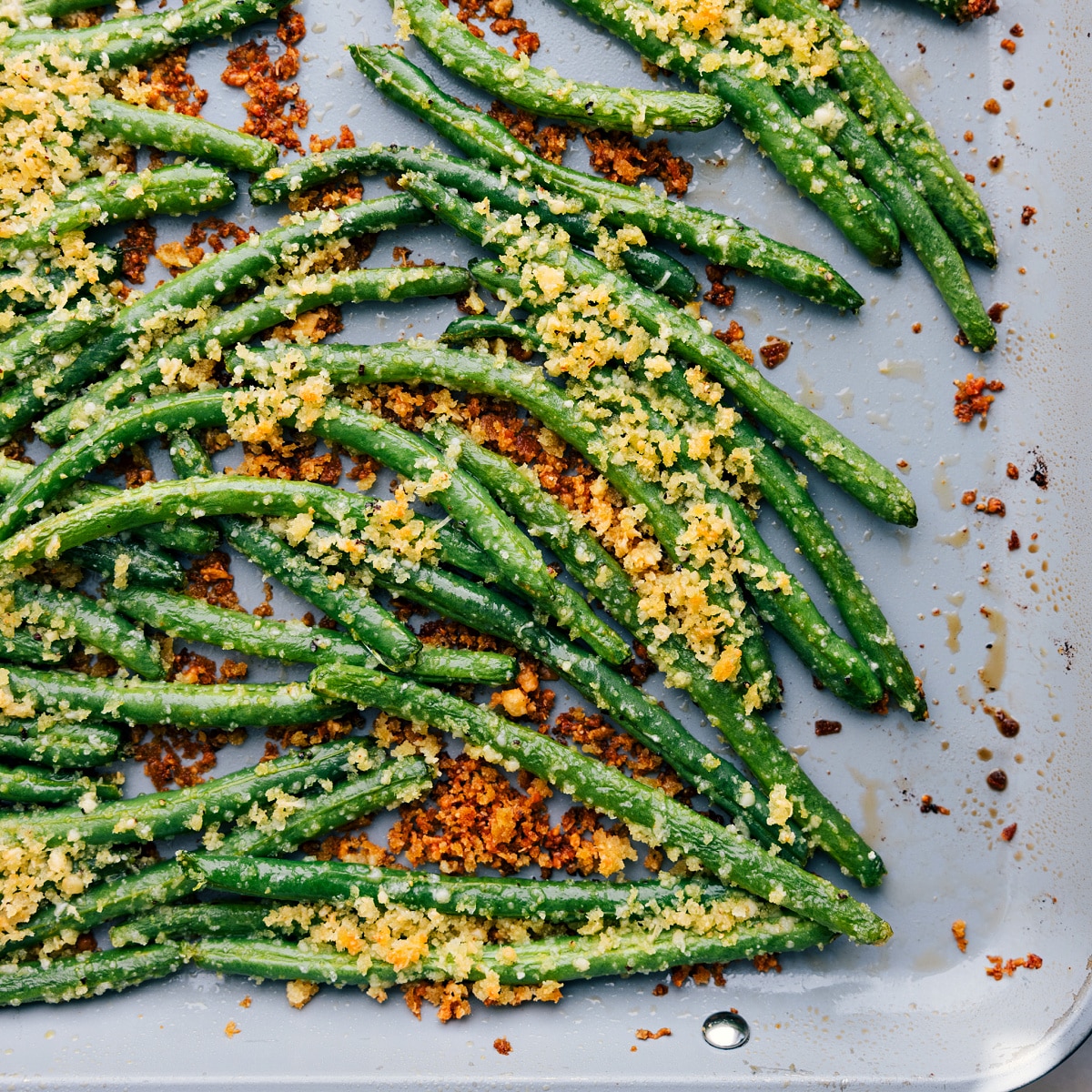 Veggies roasting on a tray, turning crispy and delicious.