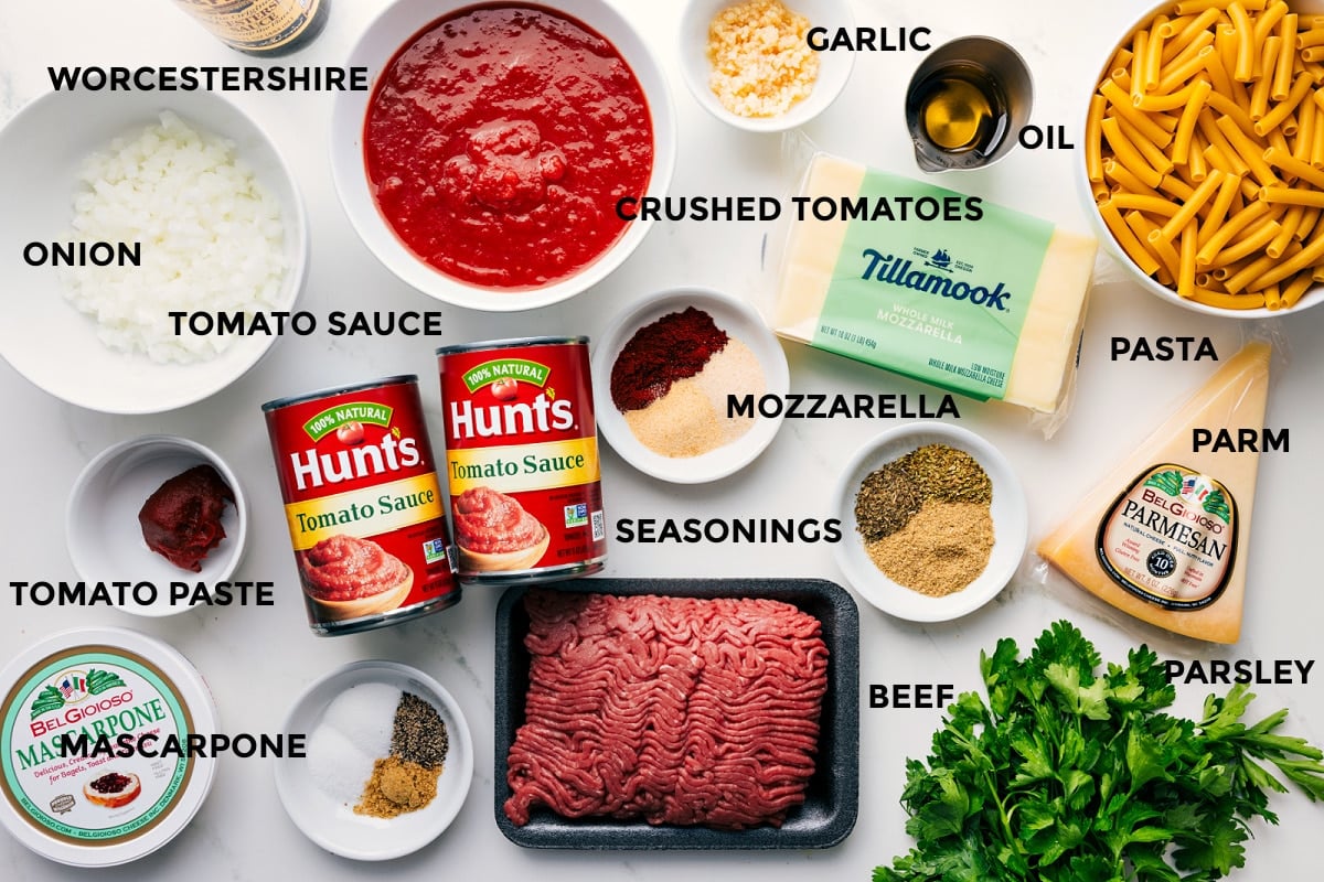 Ingredients In This Baked Ziti Recipe All the ingredients in this recipe prepped out for easy assembly including Worcestershire sauce, onion, tomato sauce, tomato paste, mascarpone, seasonings, ground beef, mozzarella, parsley, Parmesan, pasta, olive oil, garlic, and crushed tomatoes.