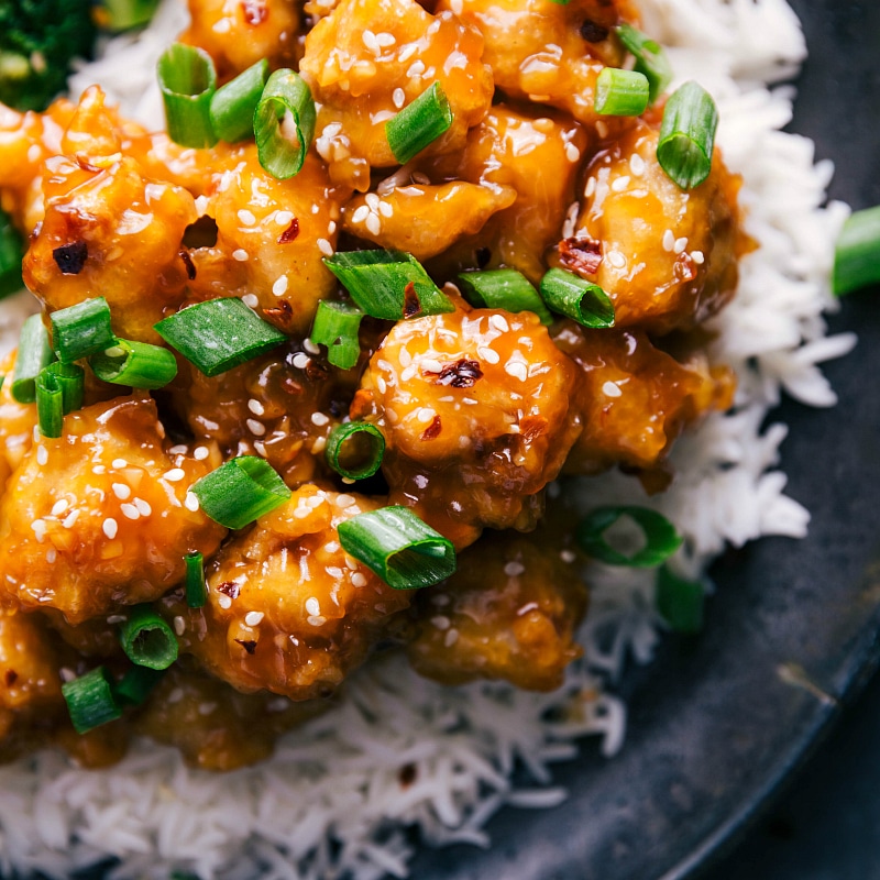 Orange Chicken, served with rice and garnished with sesame seeds and green onions