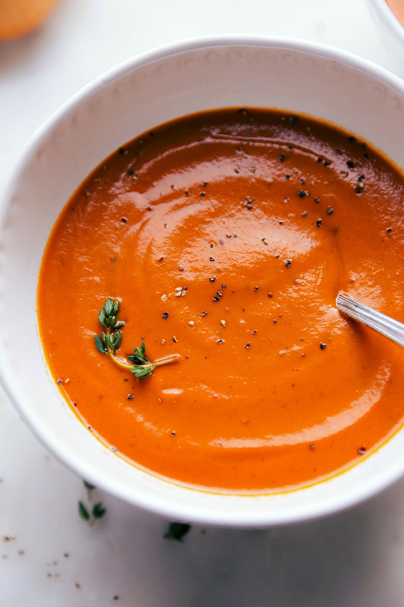 Up close overhead image of the easy tomato soup with a spoon in it