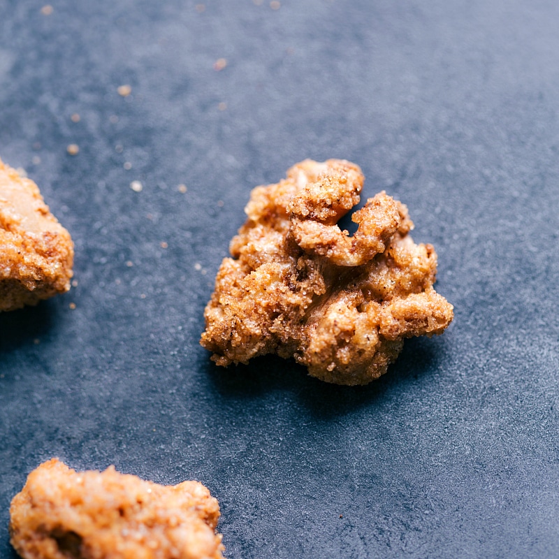 A cluster of candied walnuts, showcasing their glossy, caramelized coating and crunchy texture.