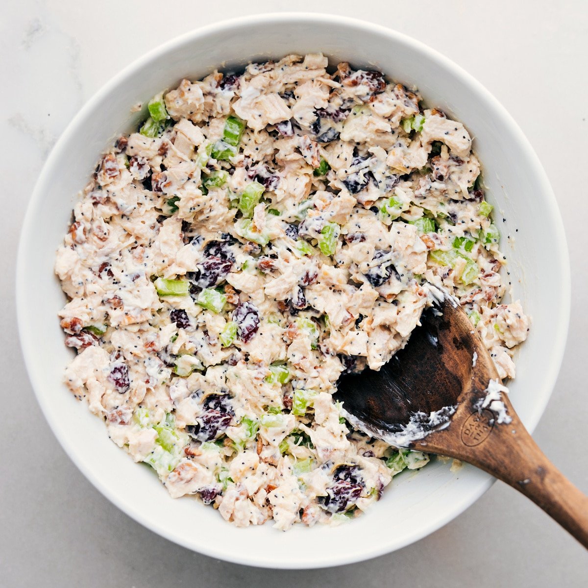 The chicken salad all combined in bowl ready to be served in some lettuce, on some bread, or however you enjoy it.