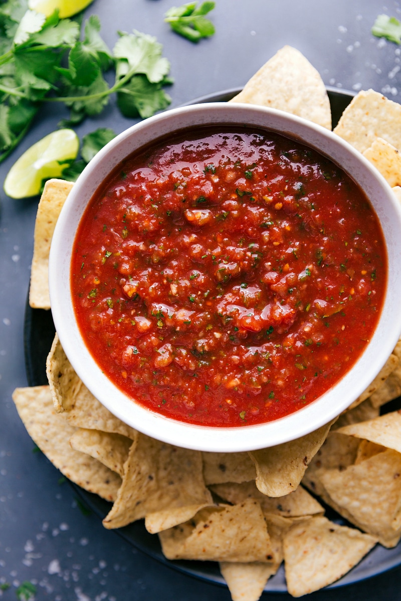 Overhead image of the salsa in a bowl, ready to be served with fresh chips on the side.