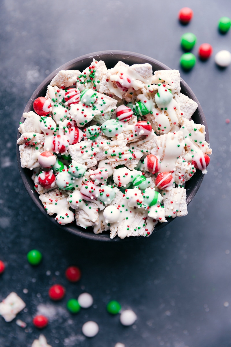 This fun Sugar Cookie Snack Mix channels the flavors of a Christmas cookie into an addicting, crunchy, sweet snack mix. Recipe via chelseasmessyapron #recipe #quick #easy #christmas #holiday #m&ms #delicious #best #sugarcookie #snack #mix Overhead view of Sugar Cookie Snack Mix.