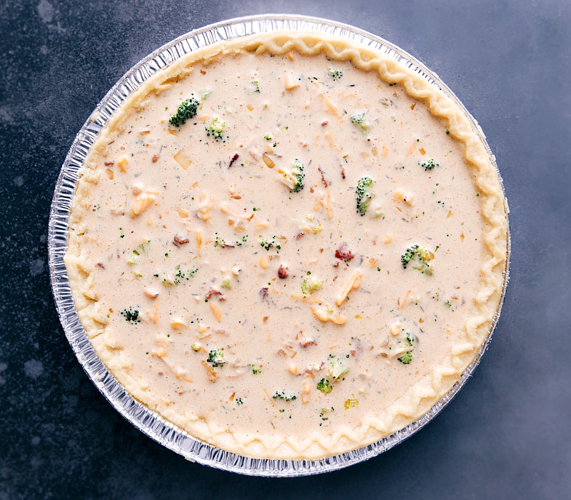 Image of the broccoli-cheddar filling in the crust for quiche.