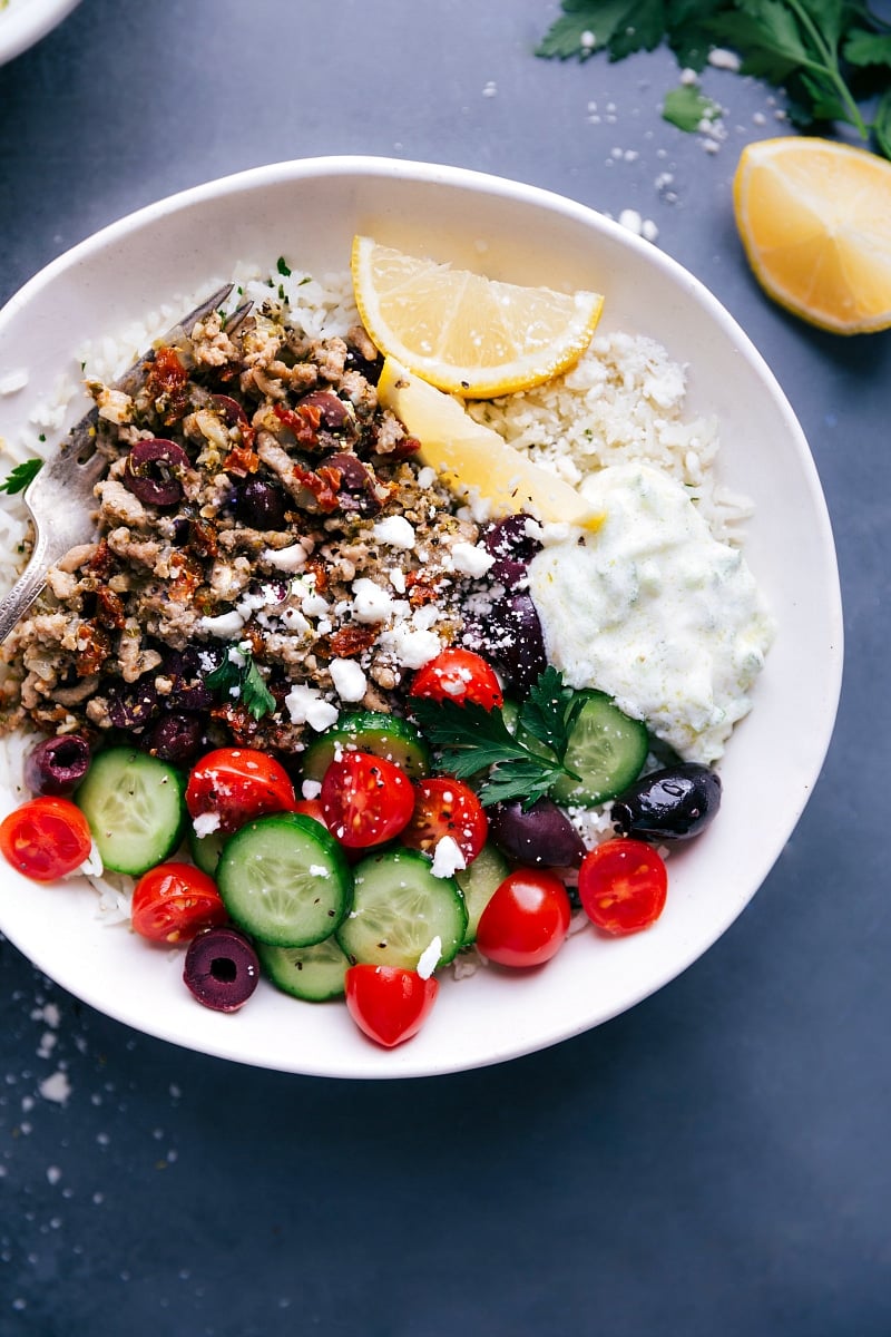 Up-close overhead image of the Greek Ground Turkey bowls with all the toppings, ready to be served.