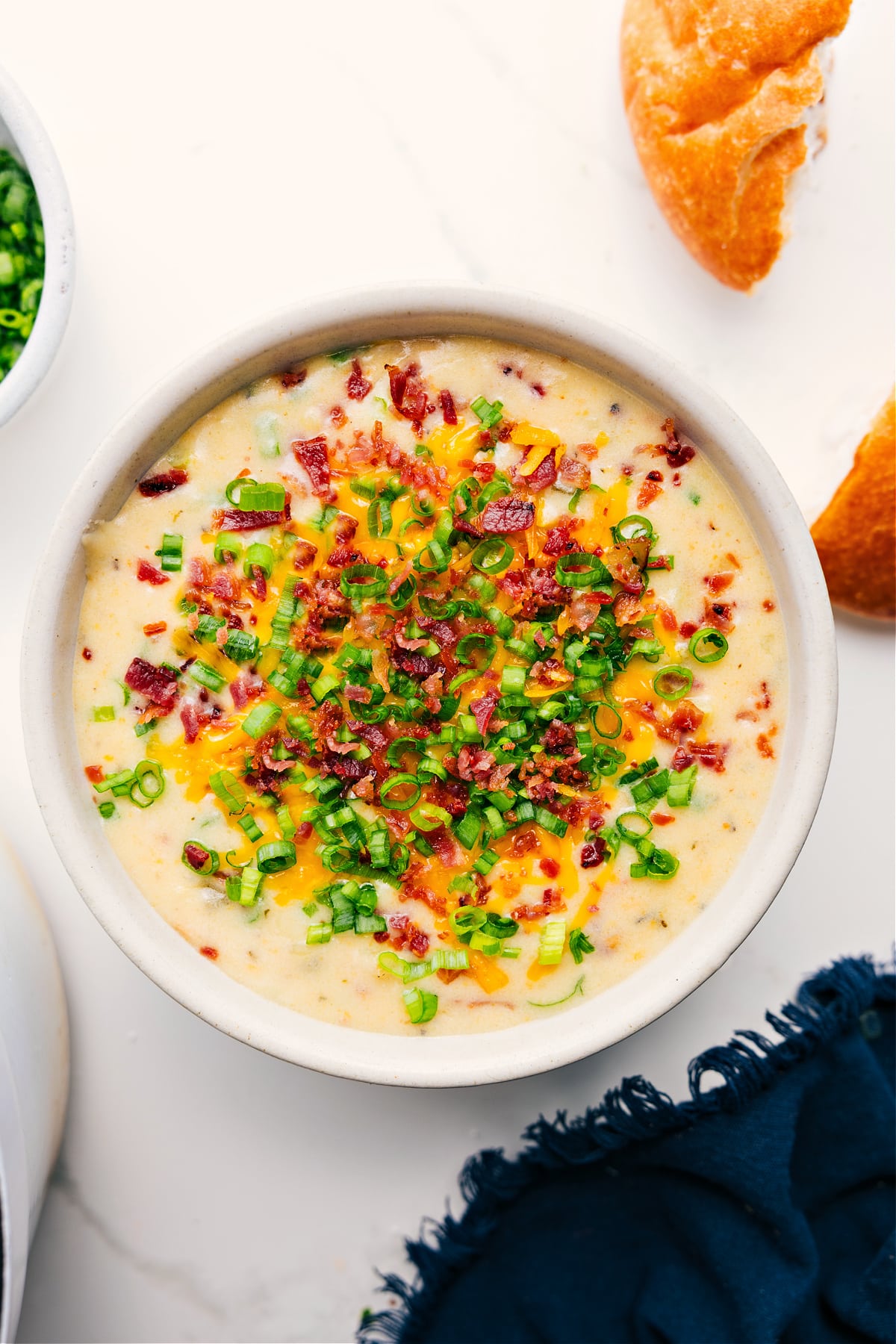 Loaded Potato Soup Recipe Ready To Be Enjoyed Loaded Potato Soup Recipe served in a bowl, topped with crispy bacon pieces and sliced green onions.