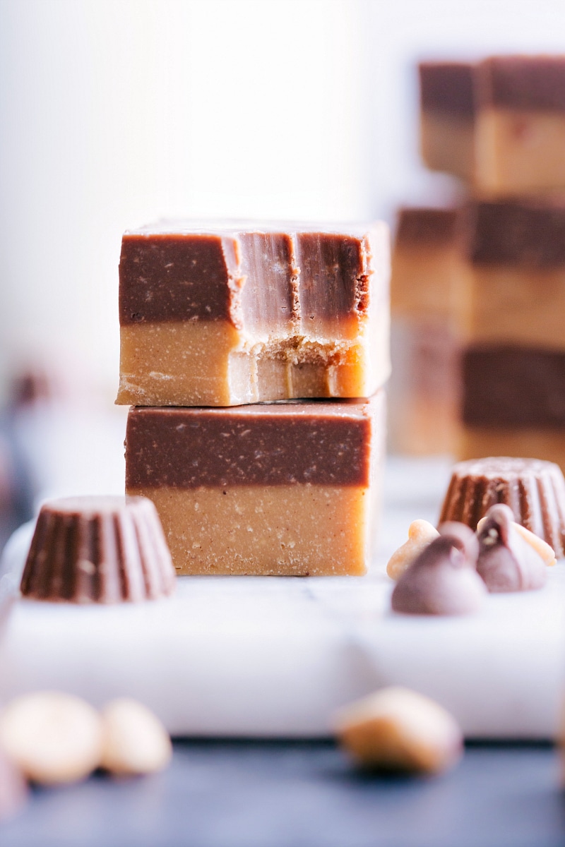 Image of two pieces of Reese's Fudge stacked, with the top one partially eaten.