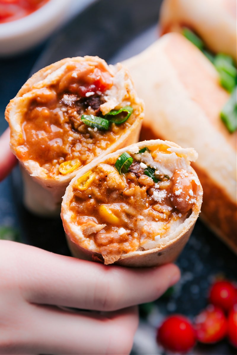 Up close overhead image of the bean and cheese burritos cut in half showing the inside