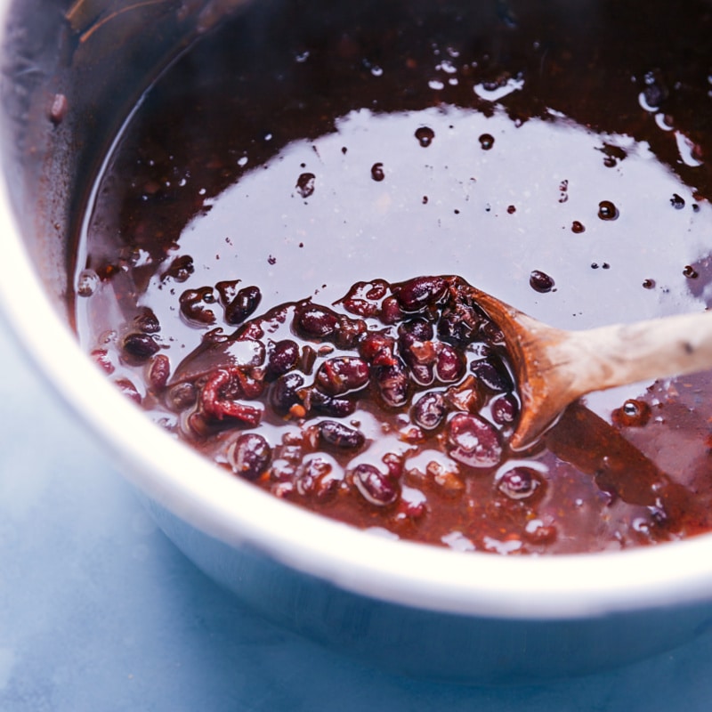 Overhead image of a pan of black beans cooking in their liquid.