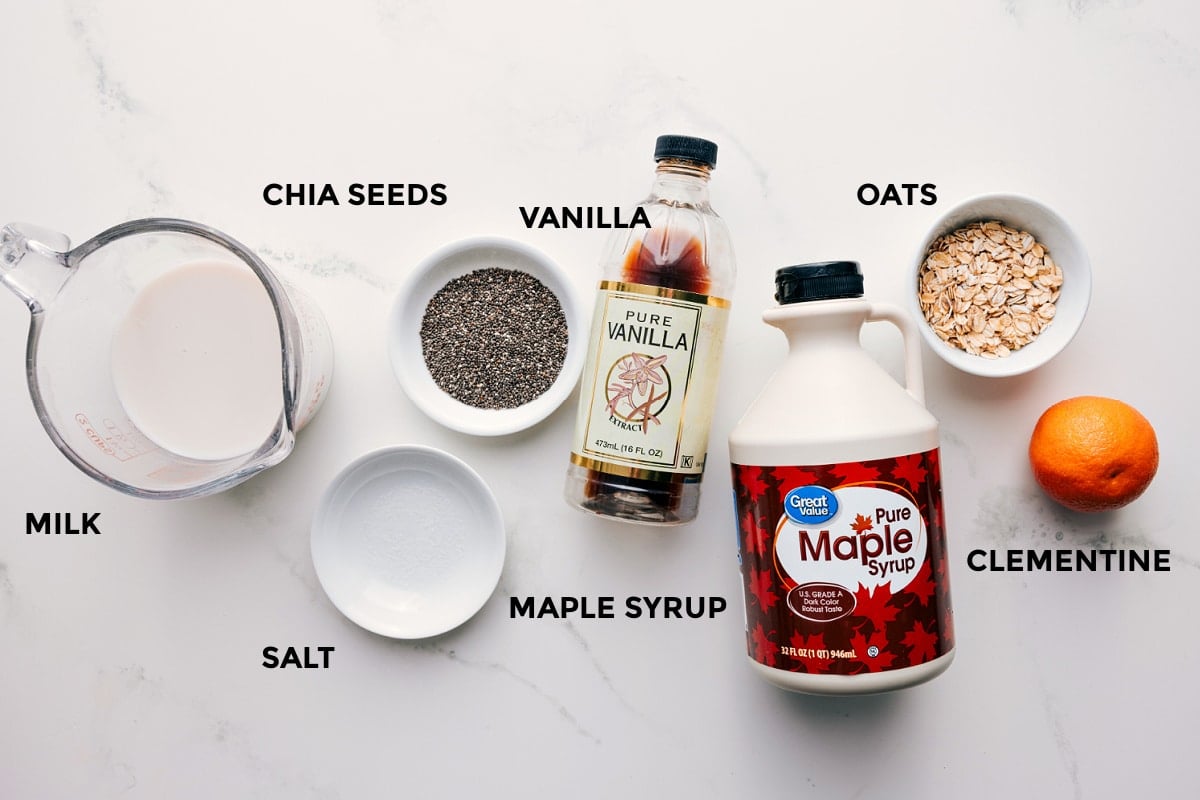 Ingredients In Chia Pudding Recipe All the ingredients in this recipe prepped out for easy assembly including the milk, chia seeds, salt, maple syrup, vanilla, oats, and clementine.