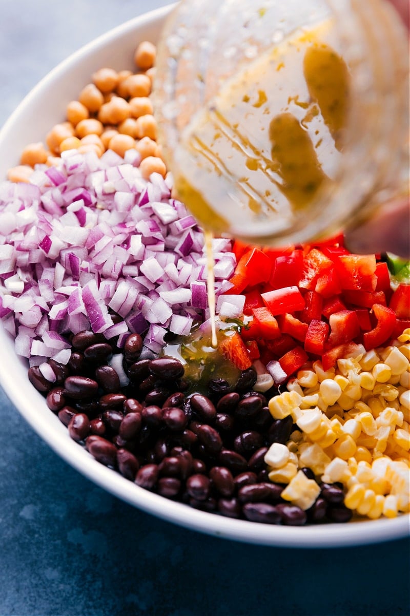 Image of the dressing being poured over the Garbanzo Bean Salad