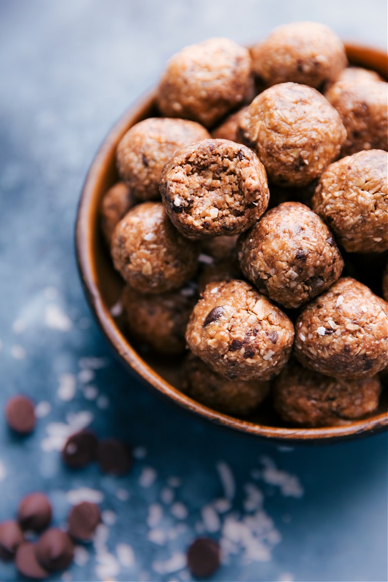 A bowl of Oatmeal Energy Bites, one with a bite taken out of it.