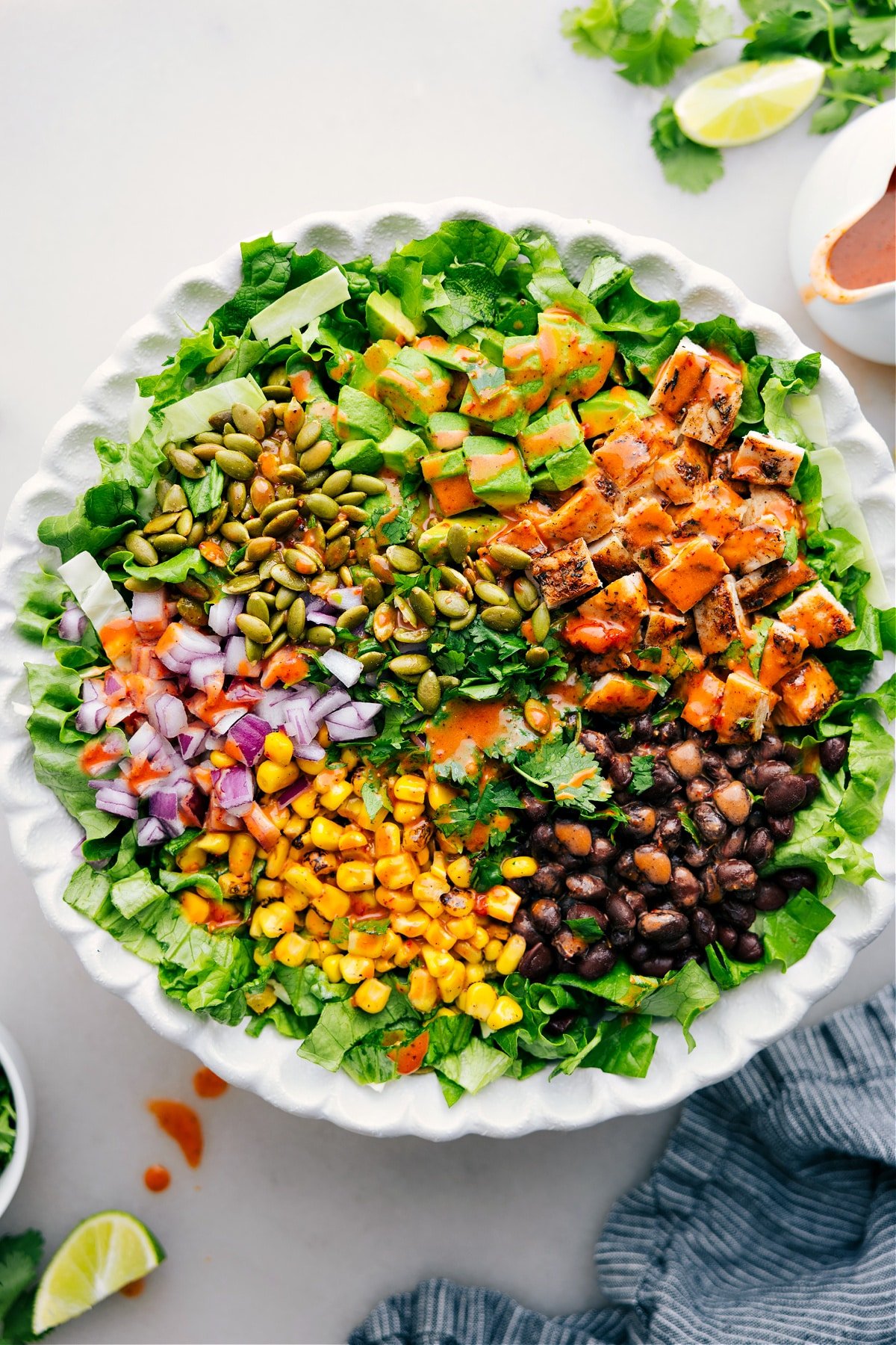 The Best Chipotle Chicken Salad Recipe Chipotle Chicken Salad featuring rotisserie chicken, avocado, corn, black beans, red onion, pumpkin seeds, and cilantro tossed in chipotle-lime vinaigrette.