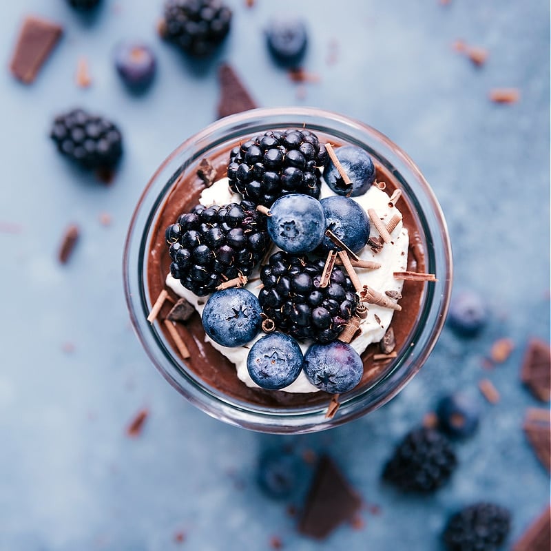 Chocolate Chia Seed Pudding with whipped cream and fresh berries on top