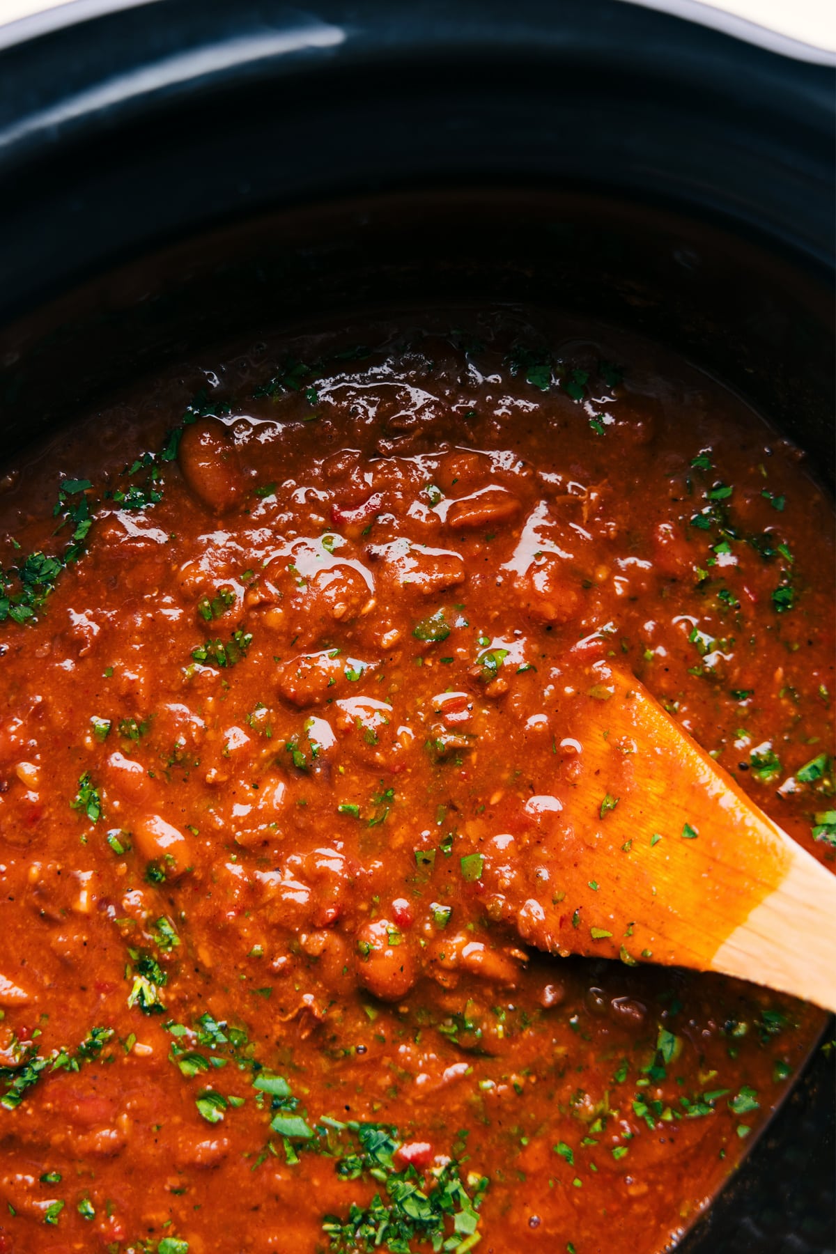You won't believe how simple these from-scratch Pinto Beans are -- no soaking required! These delicious beans are deeply savory with a smoky flavor and have the best creamy texture! Recipe via ChelseasMessyApron.com #pintos #pintobeans #instantpot #crockpot #slowcooker #nosoak #easy The dish freshly sow cooked and topped with cilantro to be served and enjoyed.