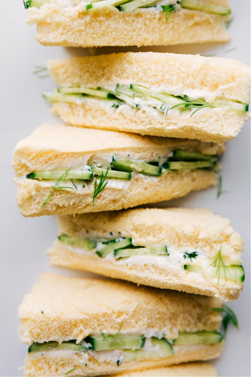 The cucumber sandwiches on a platter ready to be served and enjoyed.