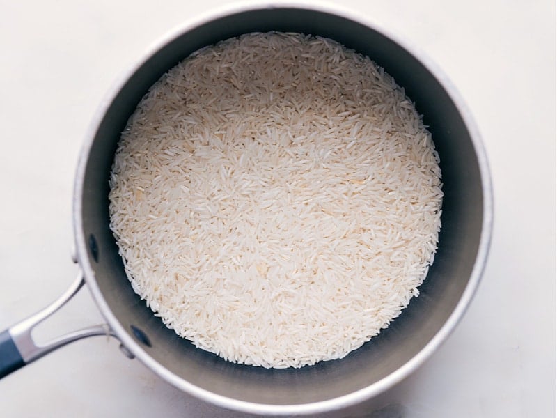 Adding rice to the pot.