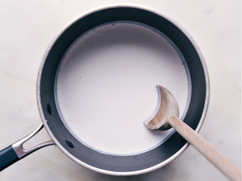 Image of all the other ingredients being added to the pot and being mixed together for this Coconut Rice