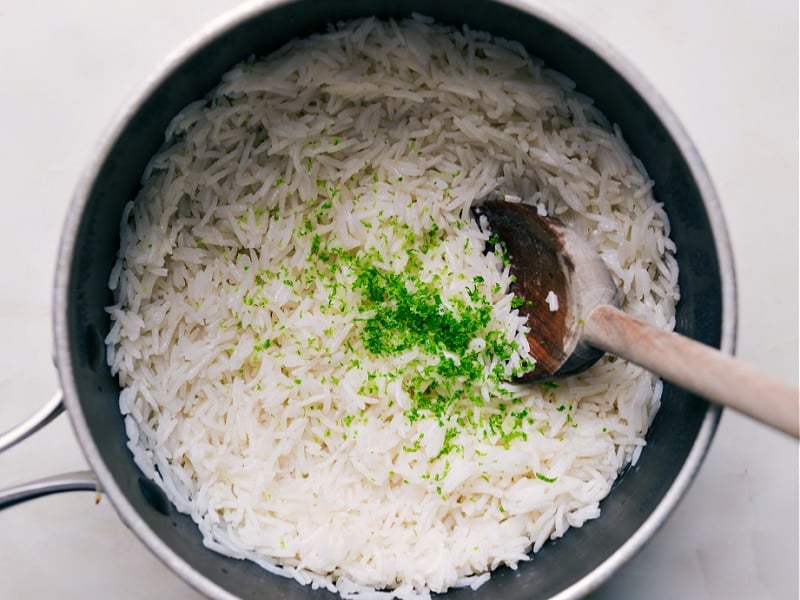 Adding lime zest and juice to the coconut rice.