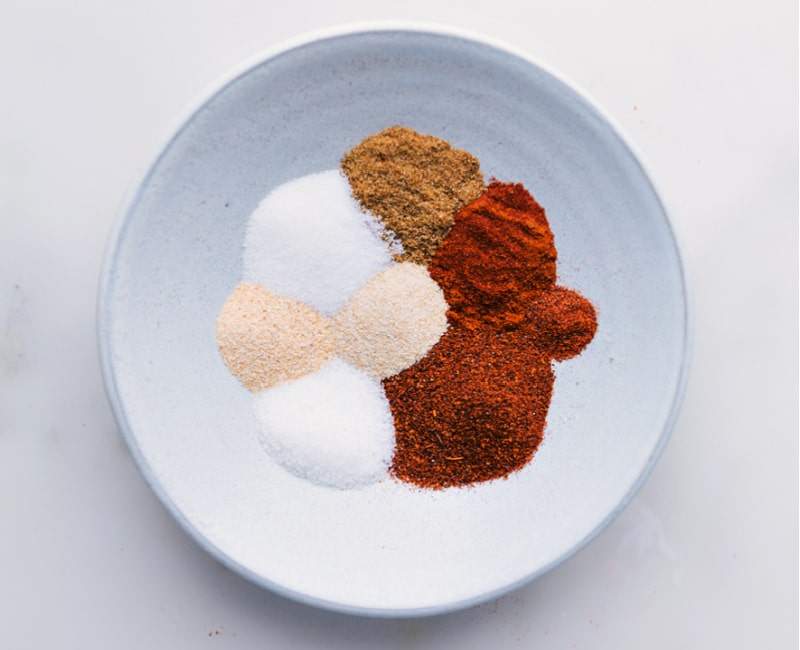 Overhead image of all the spices added to a bowl