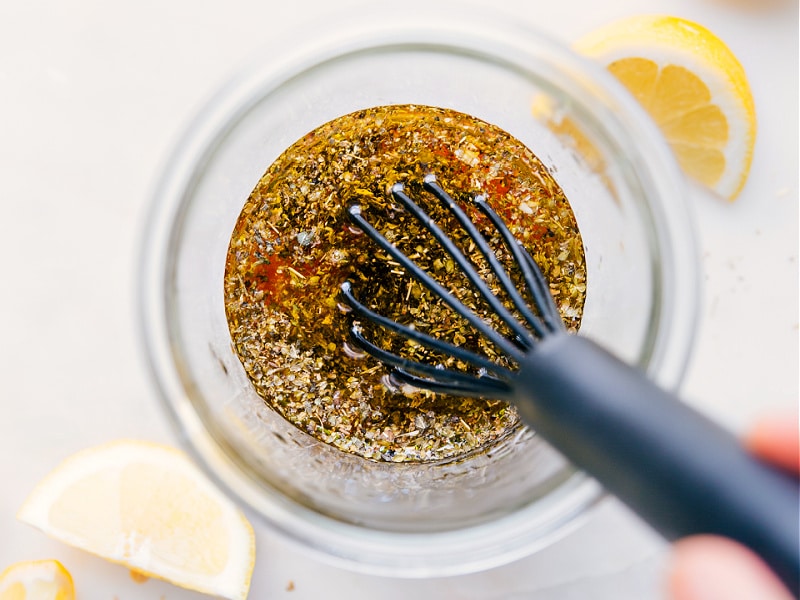 Image of the Greek Salad Dressing being whisked together