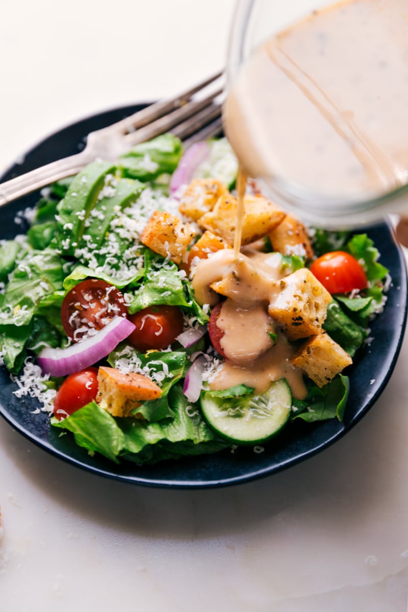 Image of the Italian Dressing being poured over a salad