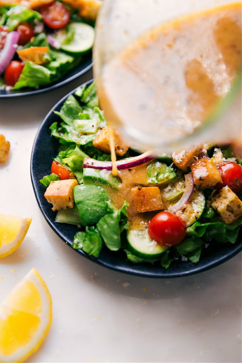 Image of the dressing being poured over the salad