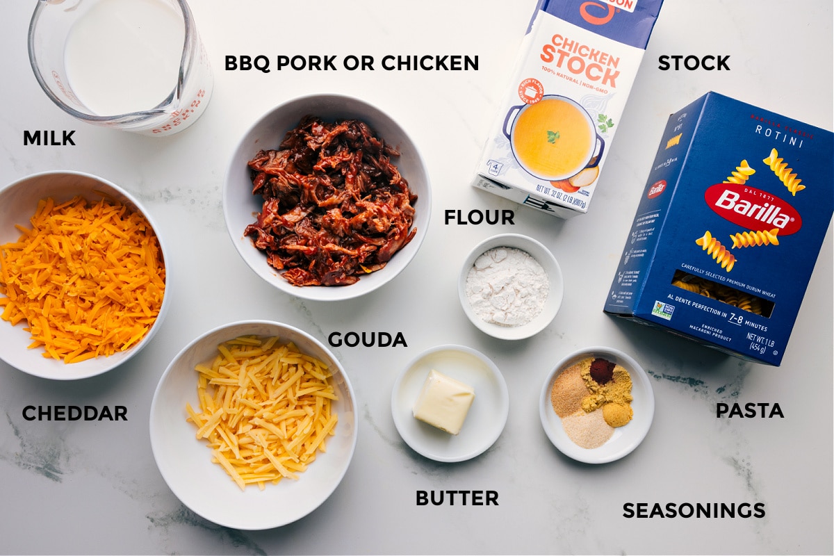 Ingredients prepped and ready for easy assembly: pork or chicken, milk, cheddar, gouda, flour, butter, seasonings, pasta, and stock.