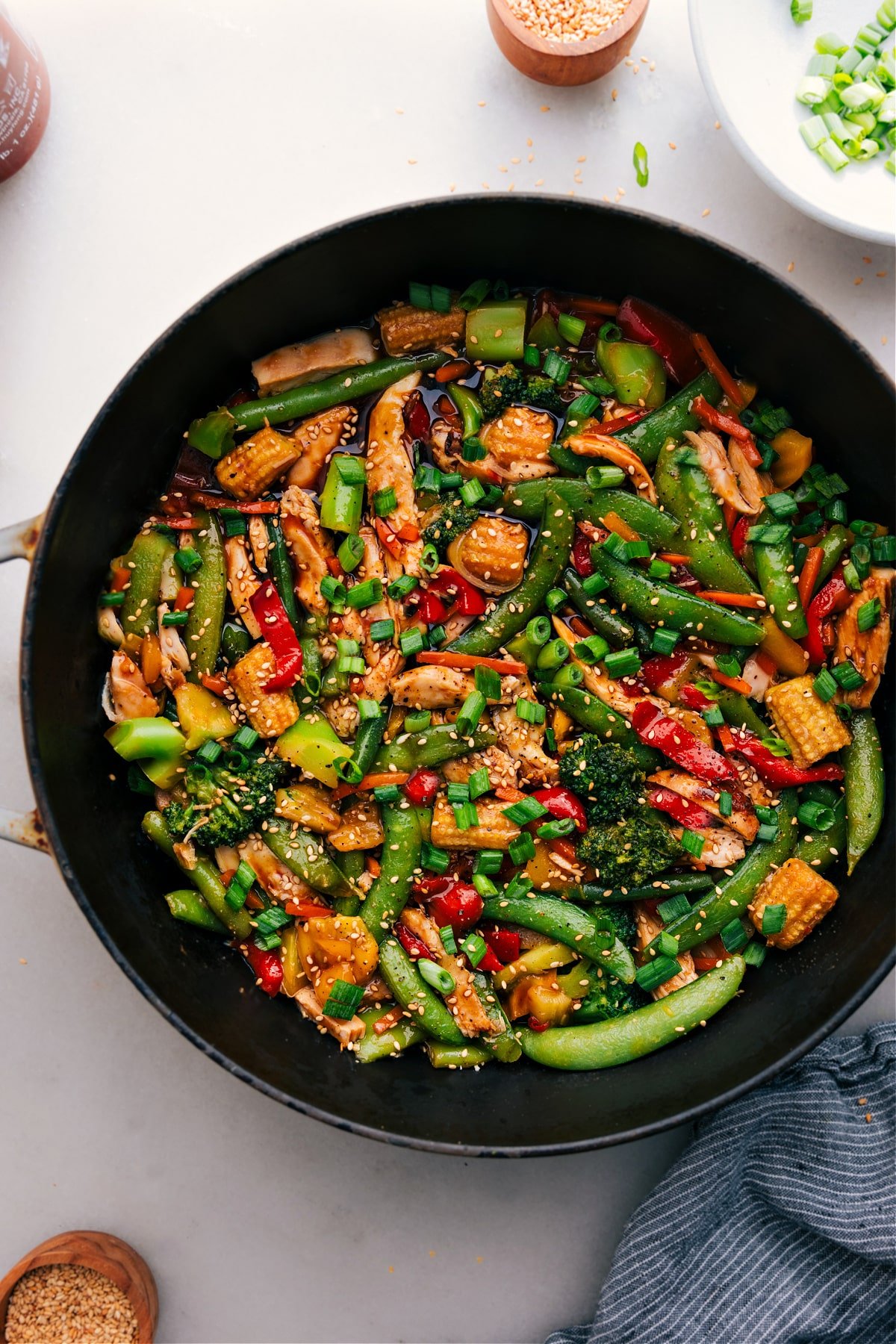 Simple And Delicious Rotisserie Chicken Stir-Fry Rotisserie Chicken Stir-Fry in the pot, topped with fresh green onions and sesame seeds.