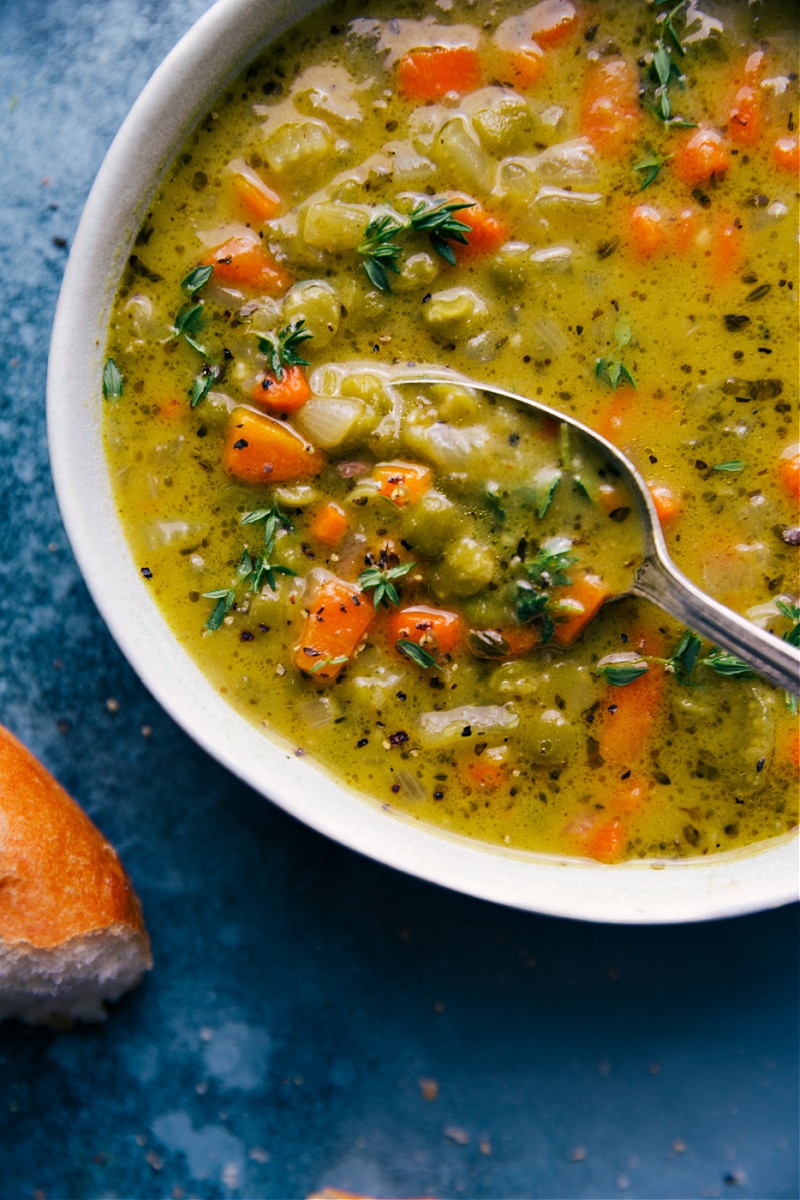 Up-close overhead image of a bowl of Vegetarian Split Pea Soup with a spoonful coming out