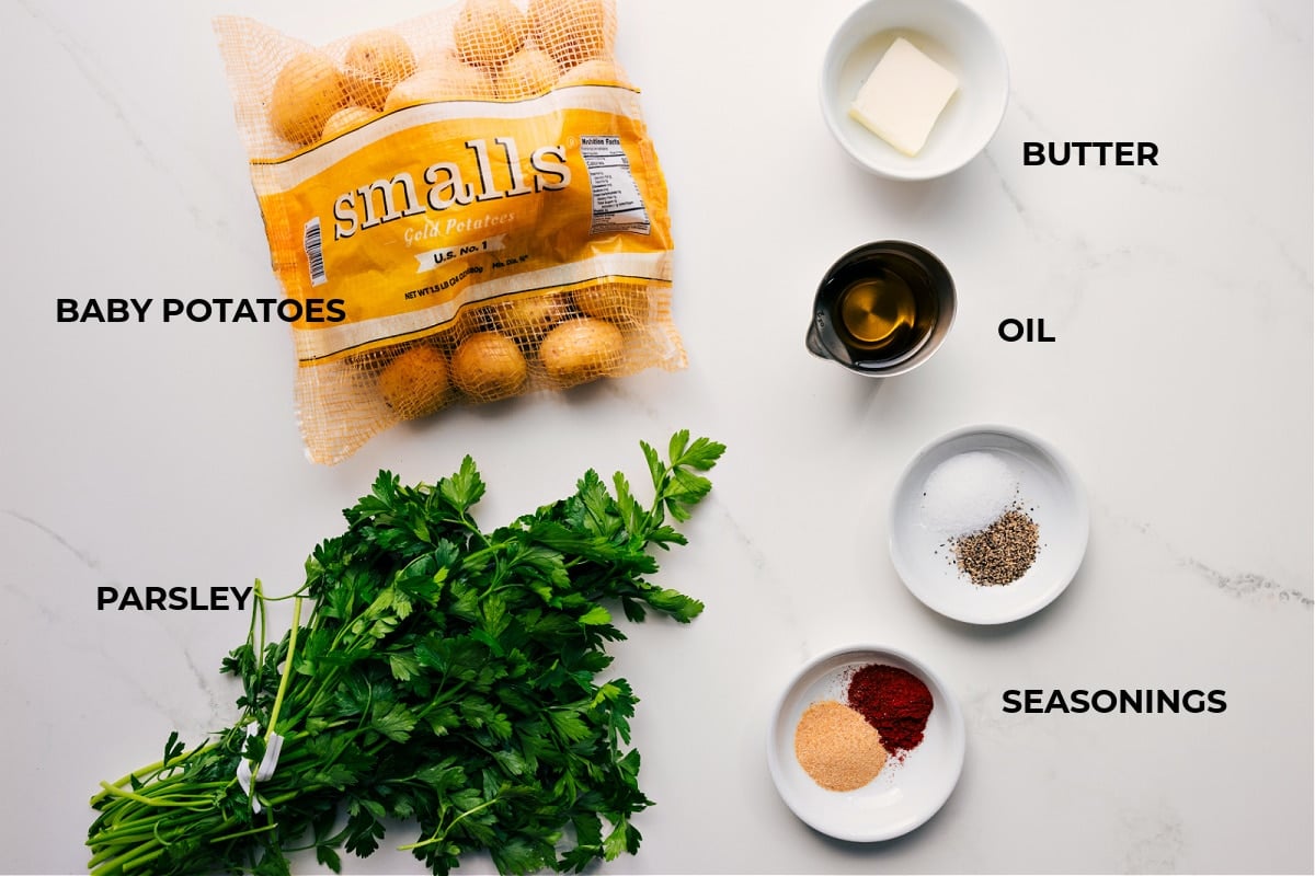 Ingredients In Smashed Potatoes Recipe All the ingredients in this recipe prepped out for easy assembly including the baby potatoes, parsley, butter, oil, and seasonings.