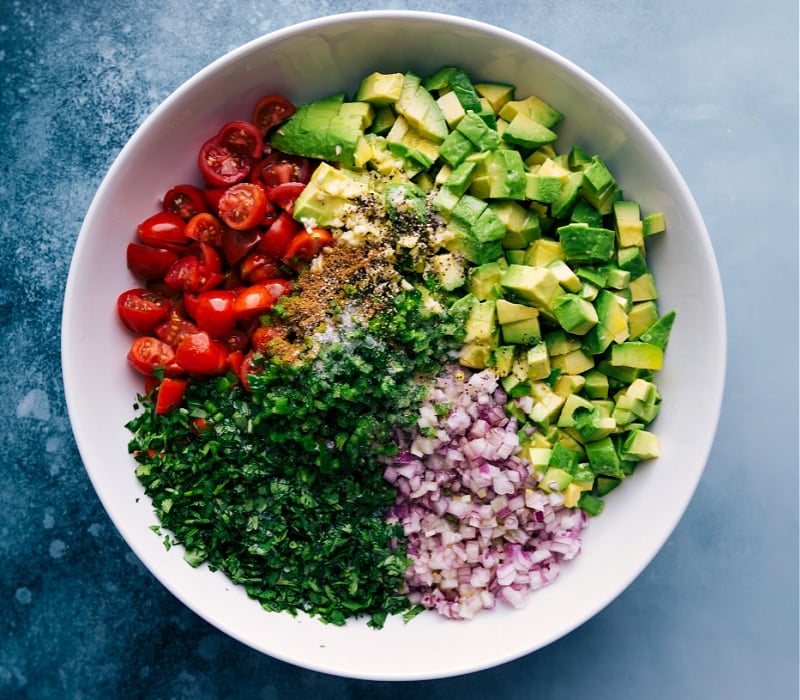 Process shots of Avocado Salsa-- image of all the ingredients being added to a bowl