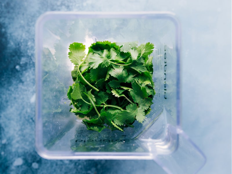 Process shots of Cilantro-Lime Sauce-- image of the cilantro being added