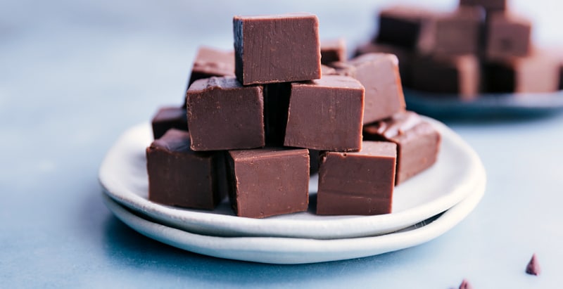 Fudge cut into squares and stacked on a plate