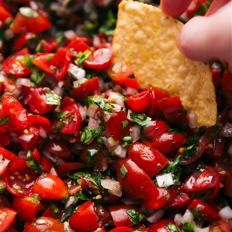 Image of a chip being dipped into the Pico de Gallo