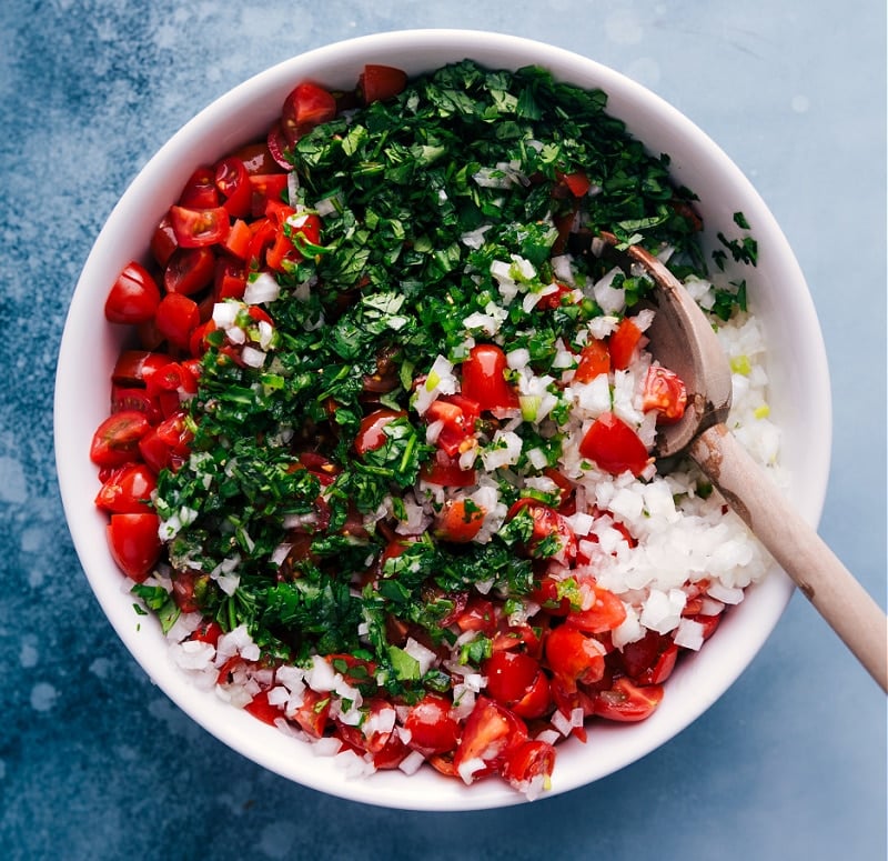 Overhead image of Pico de Gallo being tossed together