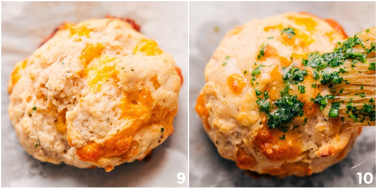 The red lobster cheddar bay biscuits fresh out of the oven with the parsley butter being spread on top.