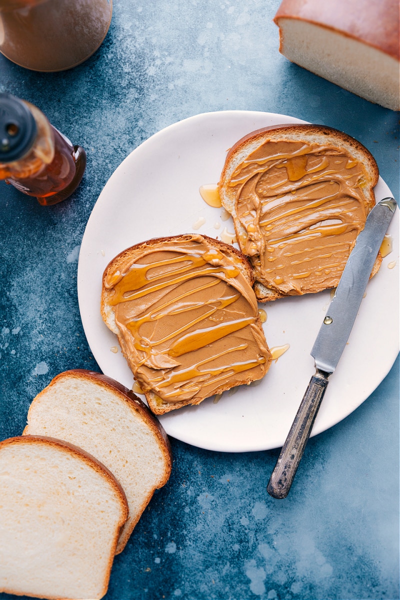 Overhead image of White Bread pieces with honey and peanut butter on top