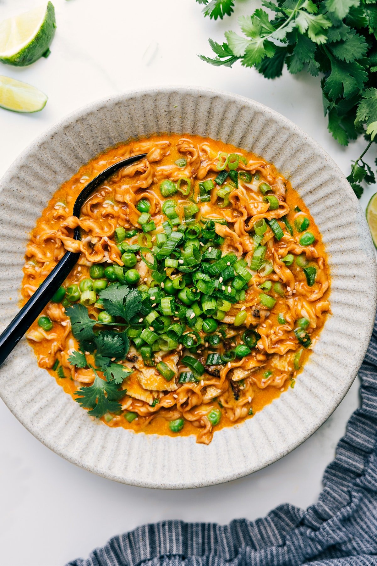 Curry Noodle Soup is an easy, family-friendly, weeknight meal that can be on the table in 30 minutes or less! A luscious coconut-curry broth is filled with bright peas, succulent ramen noodles, and tender chicken. Recipe via ChelseasMessyApron.com #curry #noodles #soup #coconut #easy #quick #familyfriendly