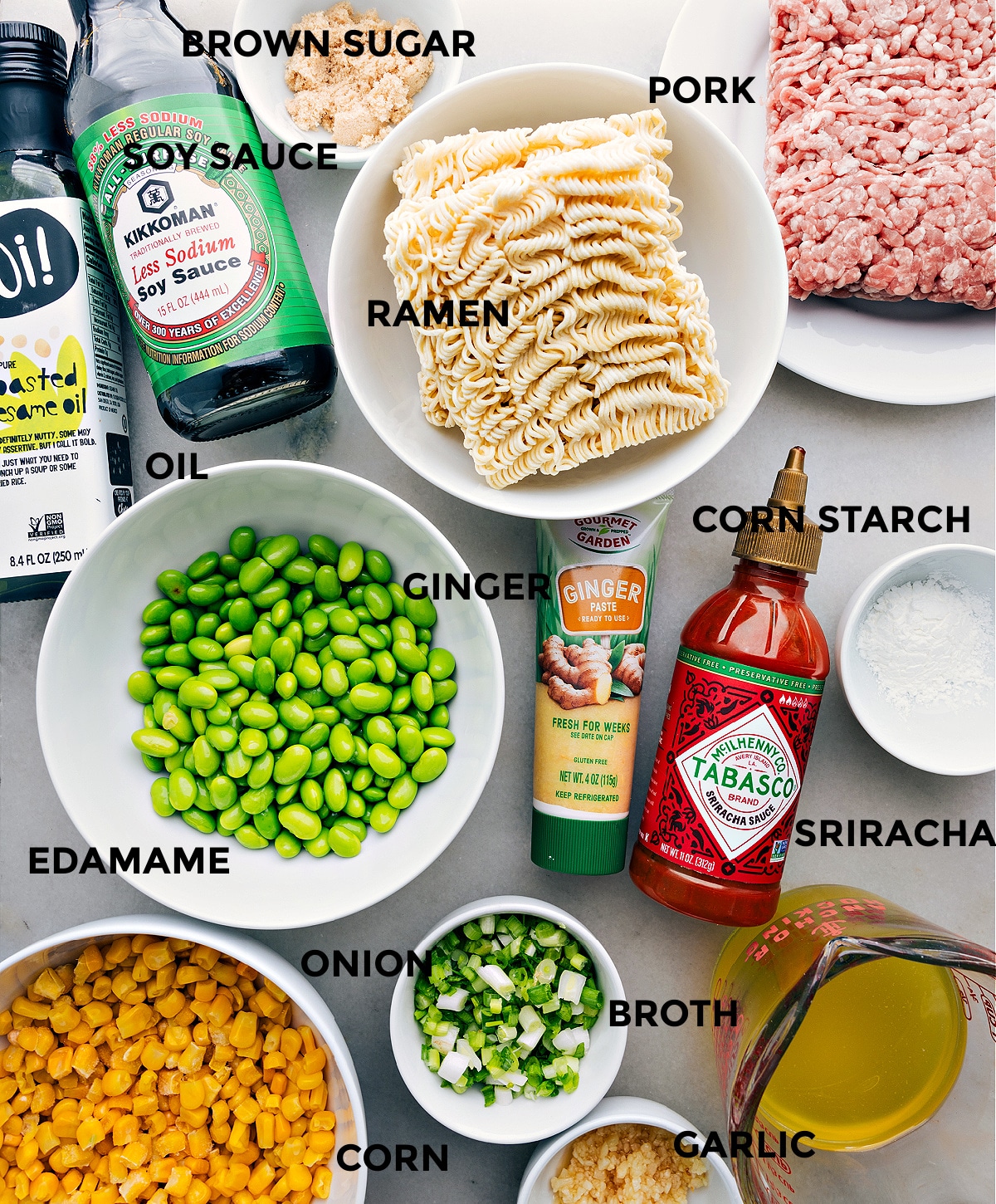 All the ingredients including brown sugar, pork, noodles, ginger, cornstarch, edamame, onion, broth, corn, and garlic all prepped out for easy assembly.