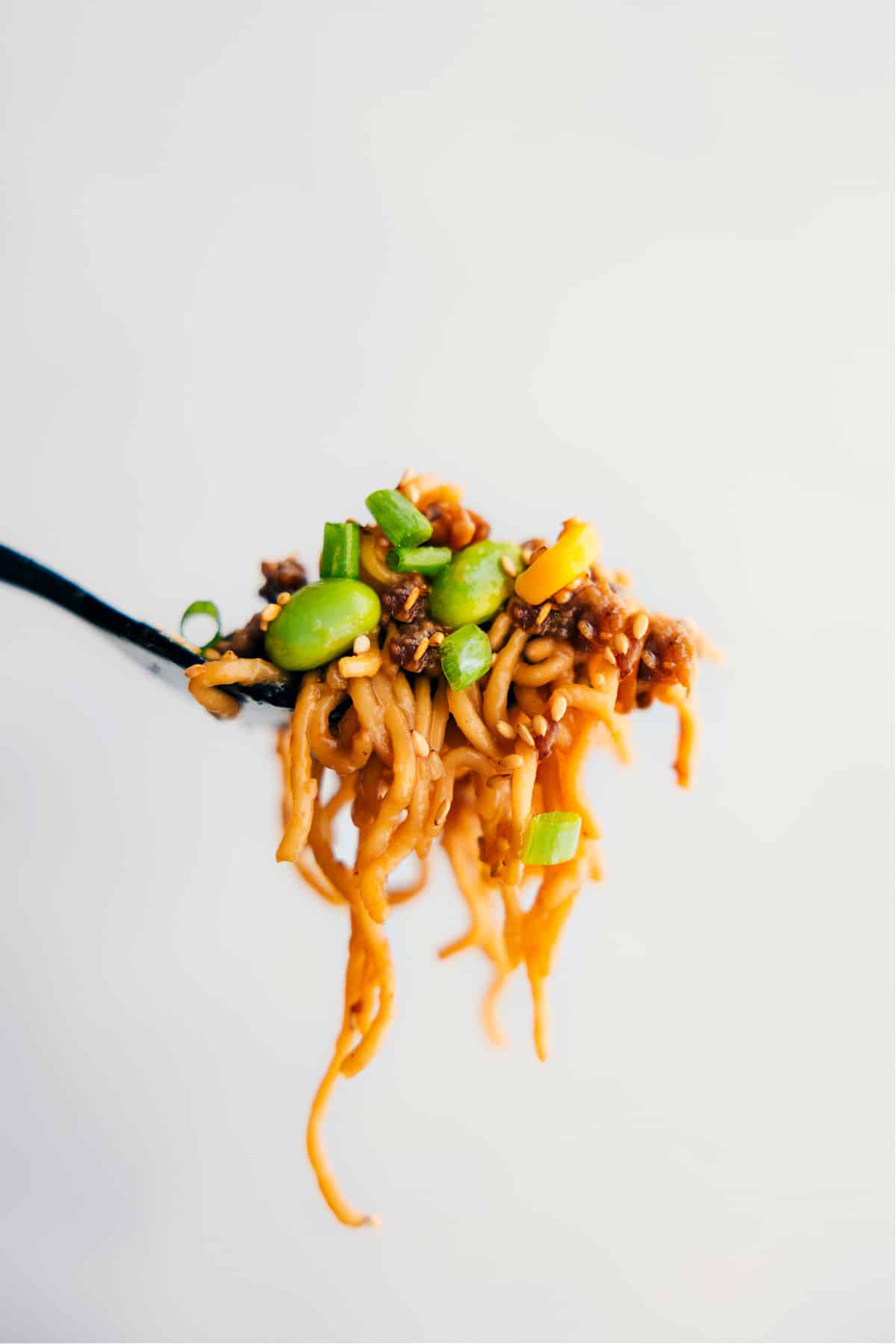 A big forkful of the Pork Ramen Stir Fry Recipe showing all the yummy ingredients.
