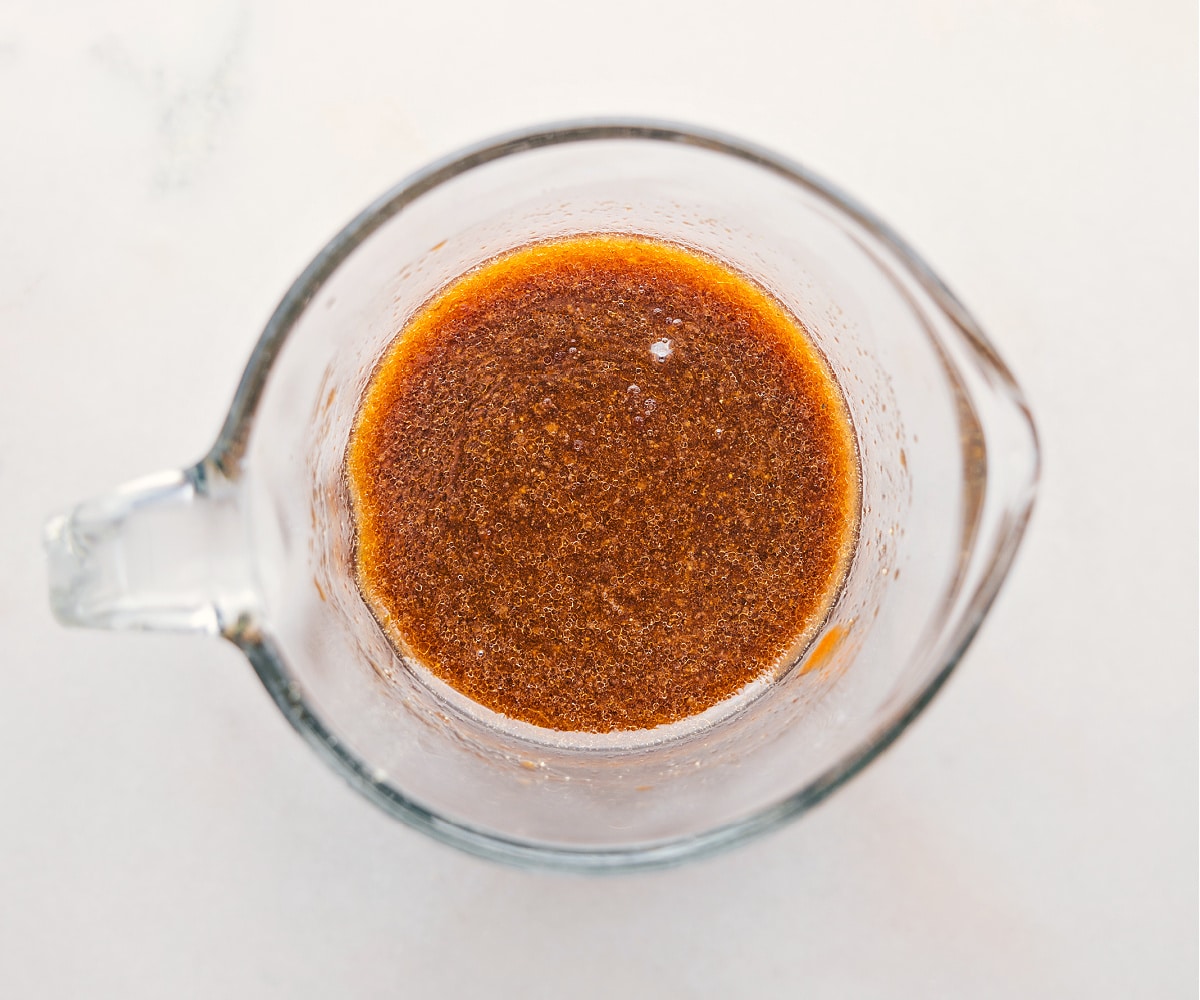 The sauce for this Pork Ramen Stir Fry Recipe being whisked together in a liquid measuring cup.