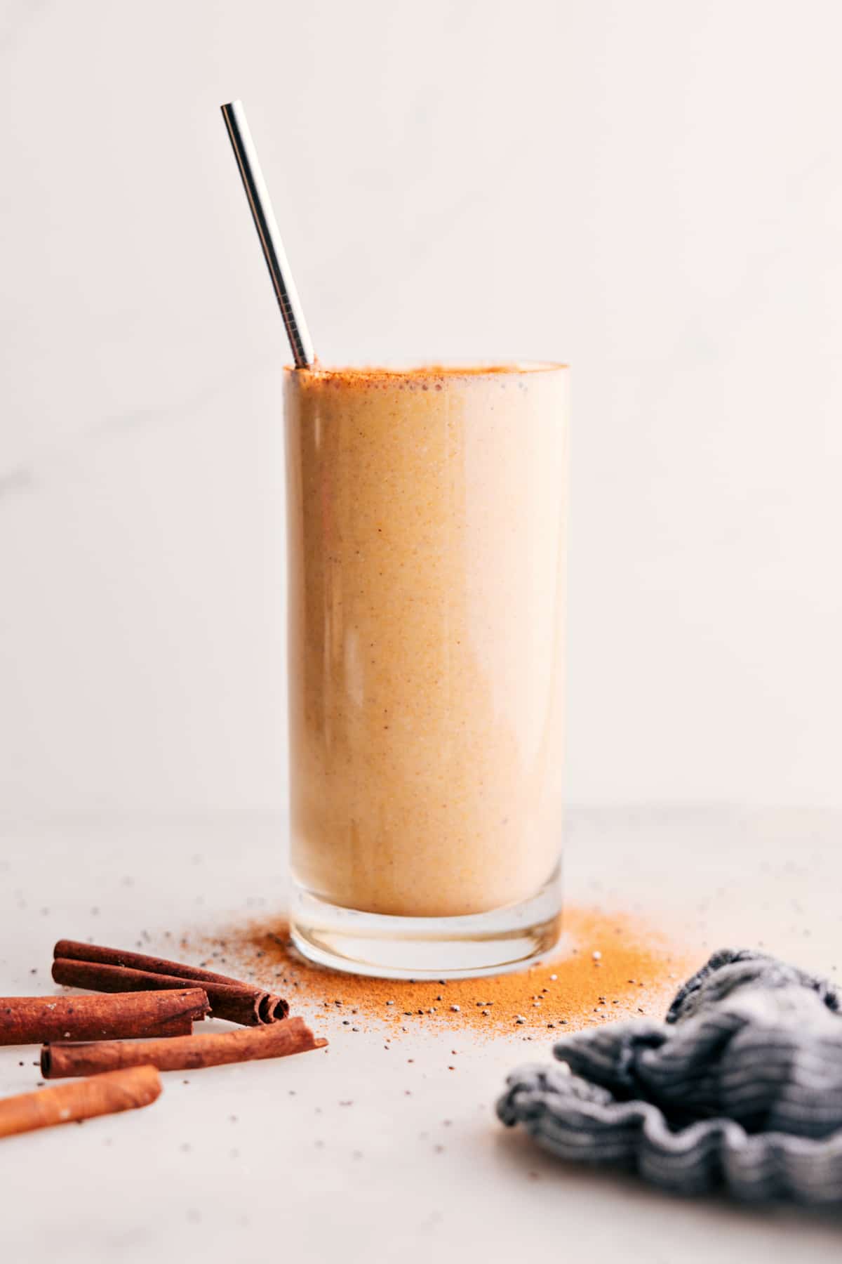Golden Milk Smoothie Is The Best A cup of Golden Milk Smoothie with a straw.