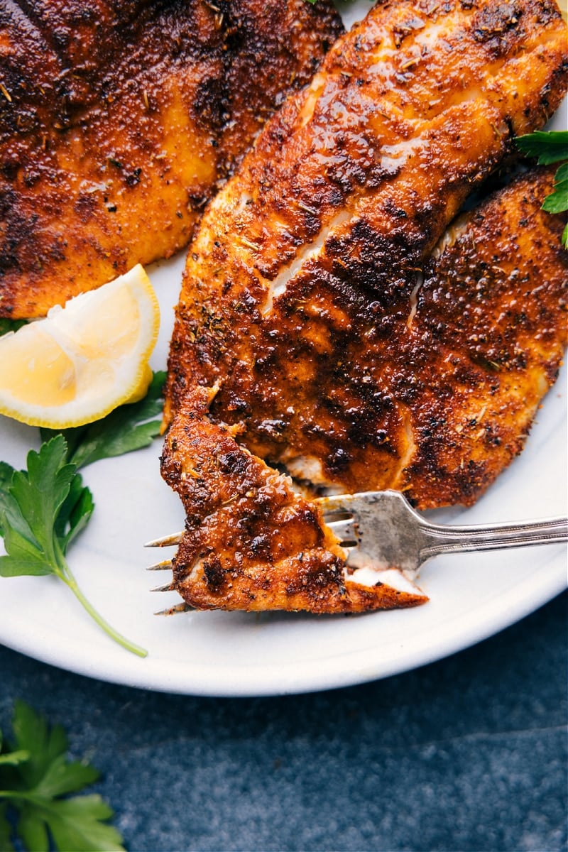 Up-close overhead image of the Air Fryer Tilapia with a bite being taken out of one of them