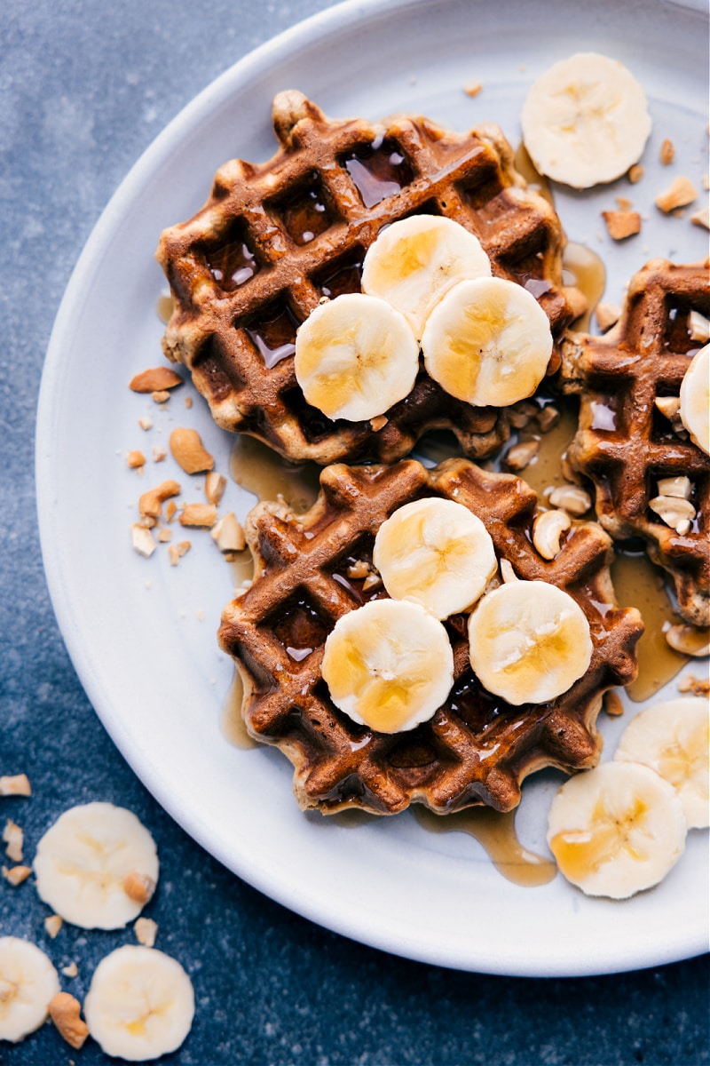 Overhead image of Banana Waffles, topped with fresh banana slices and ready to be served