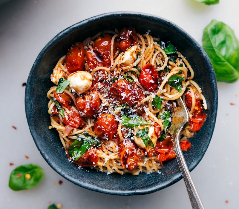 Overhead image of Caprese Pasta in a bowl with a fork in it.